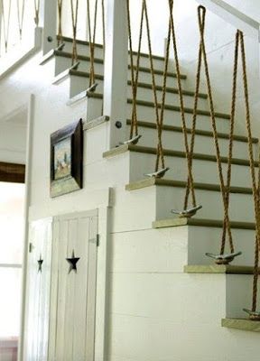 there are many birds hanging on the rope next to the stairs in this building,