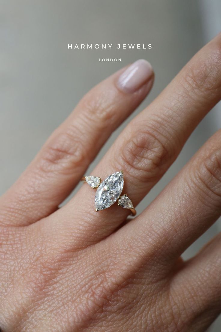 a woman's hand with a diamond ring on top of her finger and the words harmony jewels