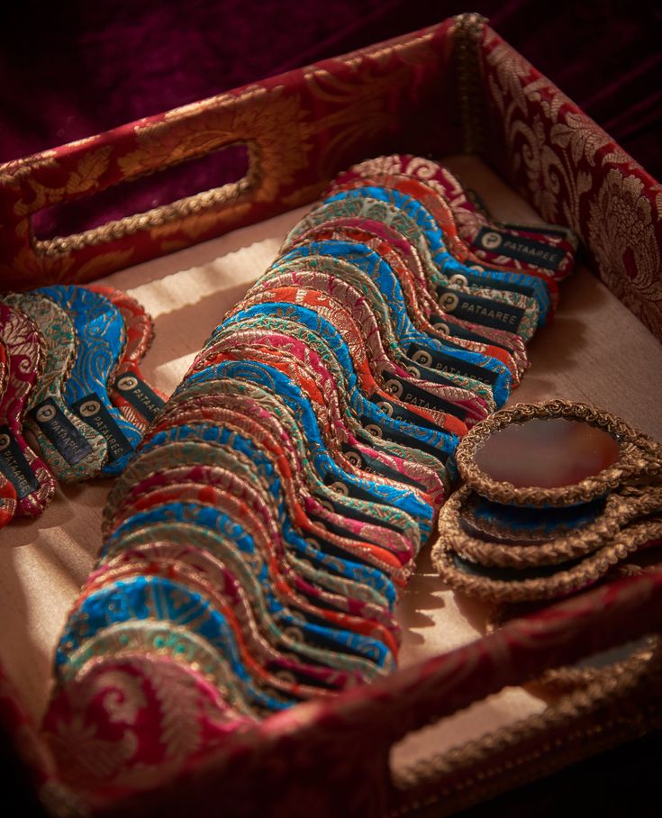 a box filled with lots of different types of brooches