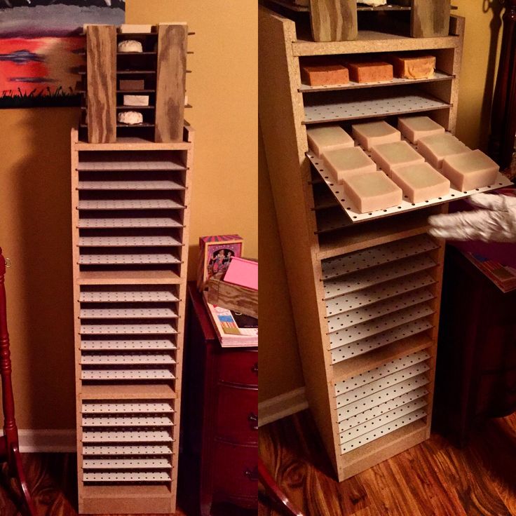 a room filled with lots of wooden shelves and boxes on top of each shelf in front of a mirror