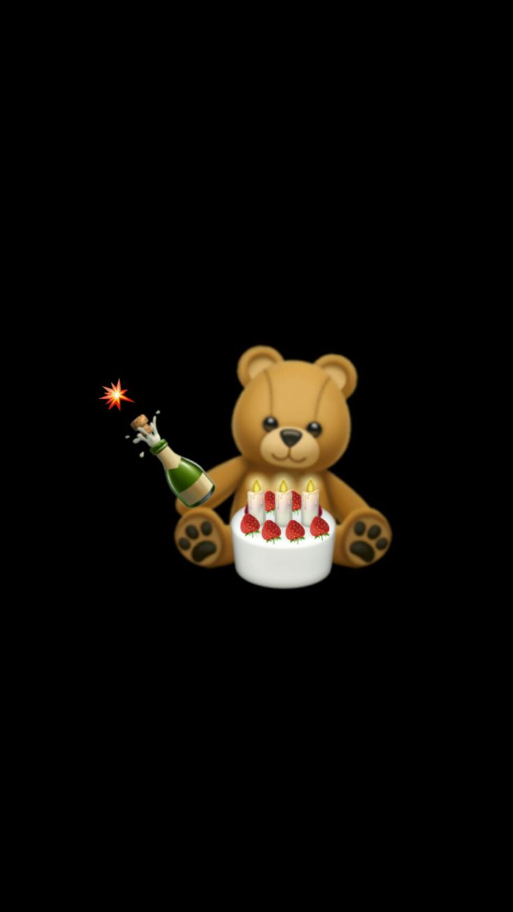 a teddy bear holding a lit candle in its paws