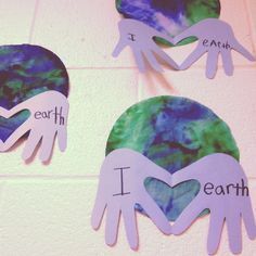 paper cutouts depicting hands and i love earth