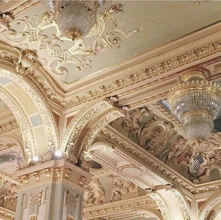 an ornate ceiling with chandeliers and paintings on it