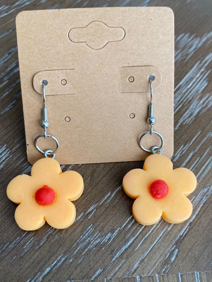 Cute flower earrings, vibrant colors, fun and unique. Trendy Flower Shaped Hoop Earrings Gift, Playful Handmade Flower Earrings, Cute Handmade Dangle Flower Earrings, Cute Flower Charm Earrings For Gift, Cute Flower Charm Earrings As Gift, Yellow Flower Charm Earrings As Gift, Whimsical Flower Charm Earrings For Gift, Whimsical Drop Earrings With Flower Charm, Orange Adjustable Dangle Flower Earrings