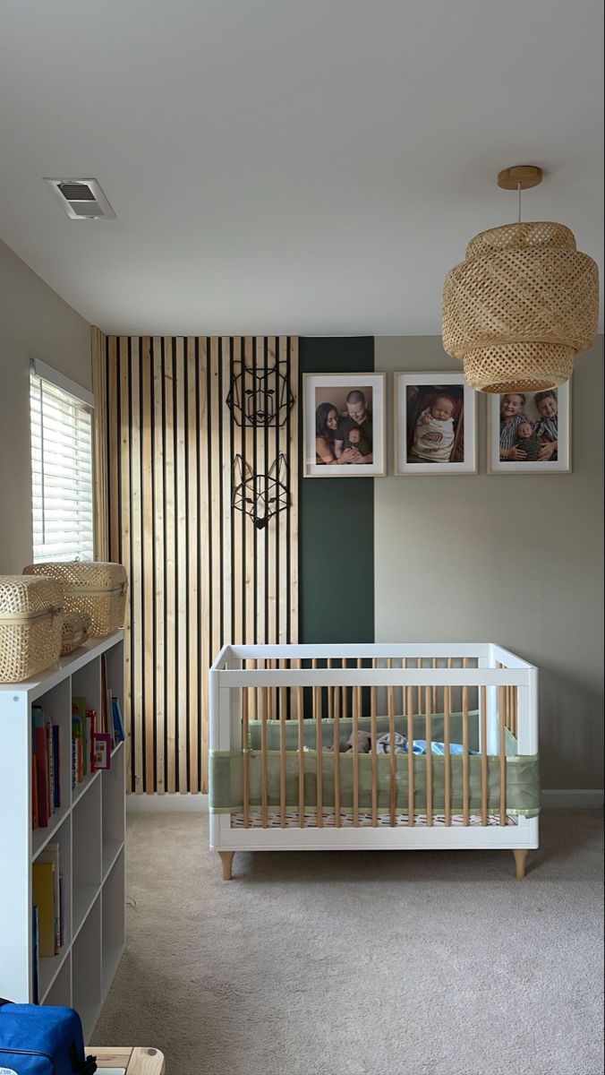 a baby's room with a crib, bookshelf and pictures on the wall