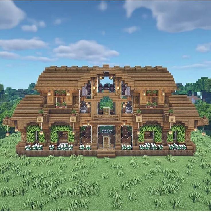 a large wooden house in the middle of a field