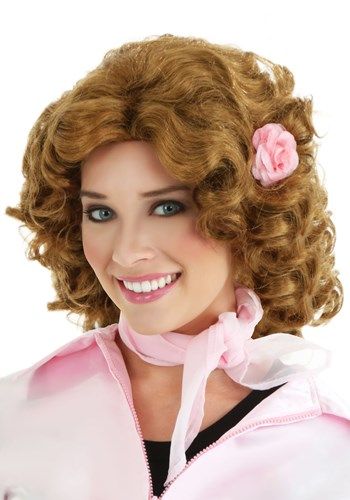 If you've always wanted to dress like Marty Maraschino from Grease, if only for a night, then you're in luck! This Grease Marty wig will transform you into the sweet girl from the Grease film. It's made from synthetic fibers that recreate her wavy style from the movie. It even has a faux flower attached to the side! It fits with an elastic band in the interior for a quick and easy way to get the character's classic look. Now all you need is a Pink Ladies jacket and a couple of pen pals, and you' Marty Maraschino, Grease Film, Grease Costume, Decades Costumes, Sandy And Danny, Pink Ladies Jacket, Grease Costumes, Grease Movie, Brown Curly Hair