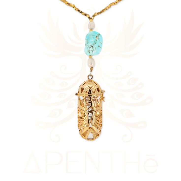 a necklace with an elephant on it and beads hanging from the front, in gold tone