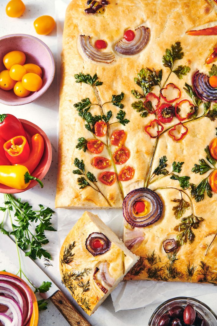 an overhead view of a pizza with tomatoes, onions and other toppings on it