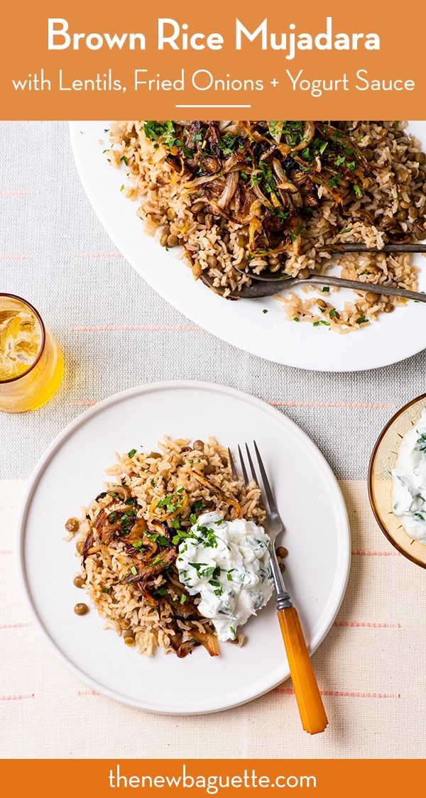 two plates filled with rice and vegetables on top of a white table cloth next to orange juice