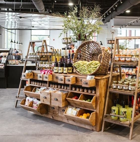 a store filled with lots of different types of food and drink on wooden shelves next to each other