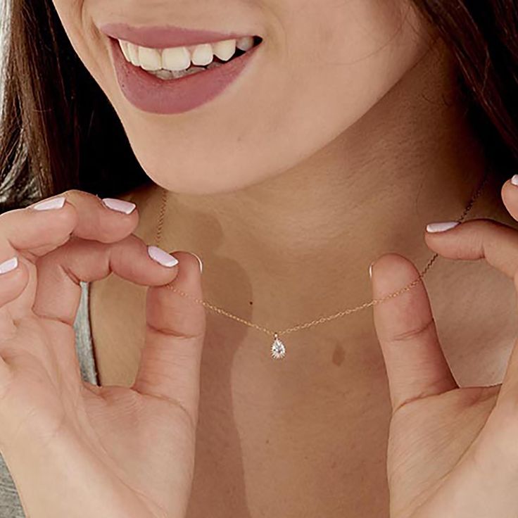 The Delicate CZ Drop Necklace features a high-quality cubic zirconia pendant in a teardrop format on a delicate 14K gold-filled chain. This tiny diamond pendant necklace is perfect for a bridesmaid necklace gift or for that special occasion. PRODUCT DETAILS: The stone is 6mm. Zirconia Stone in a 14k goldfilled setting MATERIALS: 14K Gold Filled 14K Gold Filled jewelry is not the same as gold-plated jewelry. It contains 5% of solid gold and is done by a process of heat bonding. The layer of gold Dainty Teardrop Diamond Necklace For Anniversary, Delicate Teardrop Diamond Necklace For Anniversary, Delicate Teardrop Diamond Necklace, Dainty Cubic Zirconia Drop Necklace, Fine Jewelry Teardrop Solitaire Necklace Gift, Fine Jewelry Solitaire Drop Necklace Gift, Gift Solitaire Drop Necklace In Fine Jewelry Style, Dainty Teardrop Cubic Zirconia Drop Necklace, Dainty Pear-shaped Drop Necklace For Anniversary