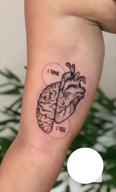 a heart and brain tattoo on the arm