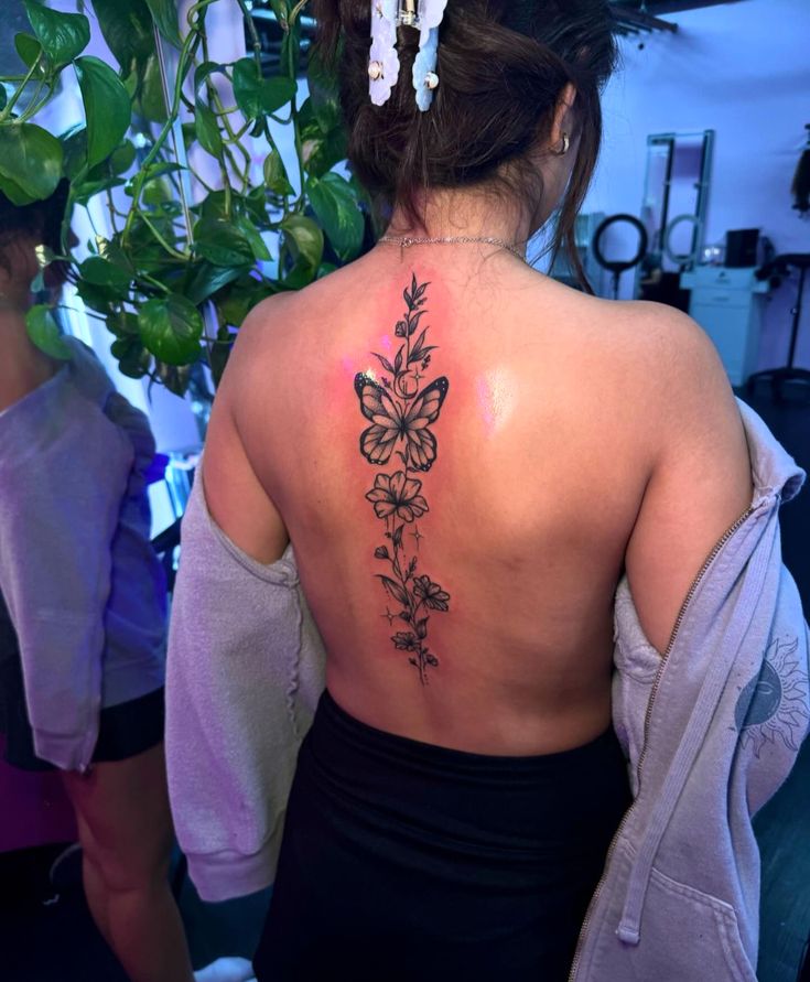 a woman with a tattoo on her back