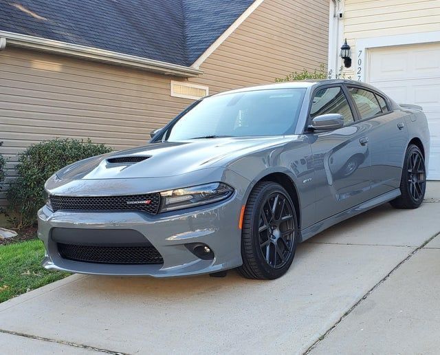 a gray car parked in front of a house