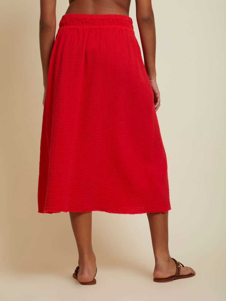 A midi skirt with a hint of bohemian romance, thanks to its breezy Double Gauze fabric and easy pull-on waist that's comfortable and flattering. (This one comes in Cherrybomb.) Wear it with the Wyoming Tank. | Women's Safa Skirt in Cherrybomb | Ethical Essentials Spring Breezy Gathered Maxi Skirt, Flowy Summer Midi-length Bottoms, Breezy Flowy Maxi Skirt With Elastic Waistband, Breezy Summer Skirt With Elastic Waistband, Flowy Lined Maxi Skirt For Daywear, Spring Midi Length Gathered Skirt, Relaxed Gathered Maxi Skirt For Summer, Breezy Gathered Skirt For Spring, Beach Midi Skirt With Elastic Waistband