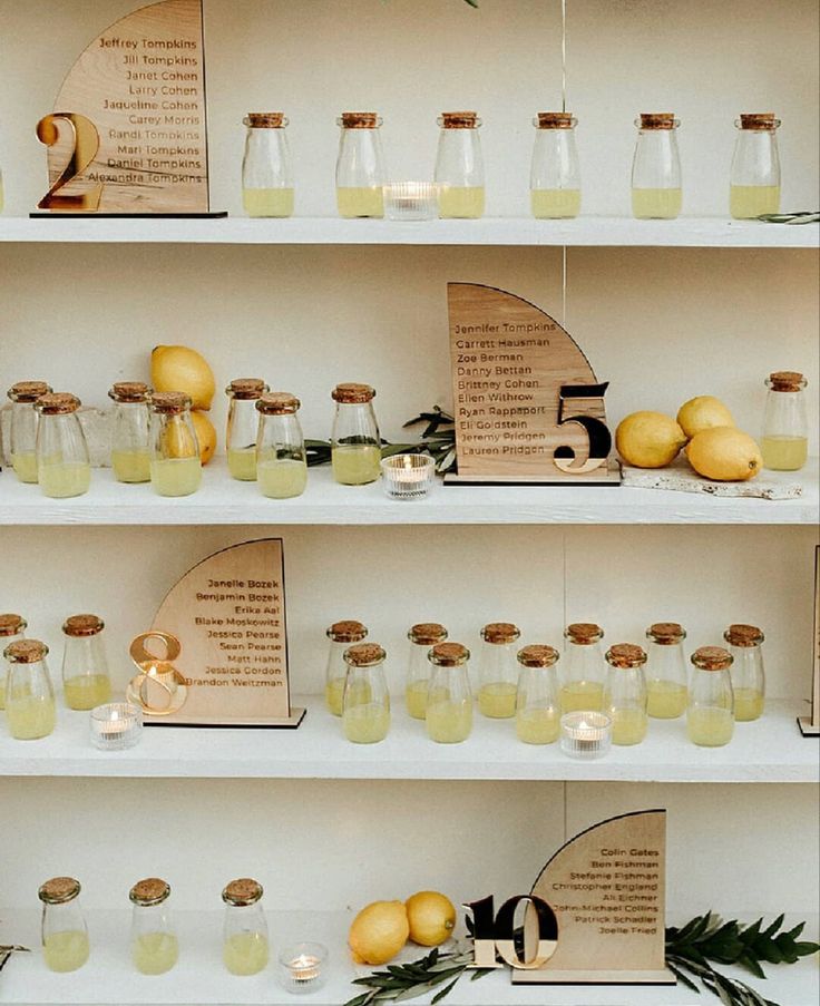 several shelves filled with jars and lemons on top of eachother's shelf