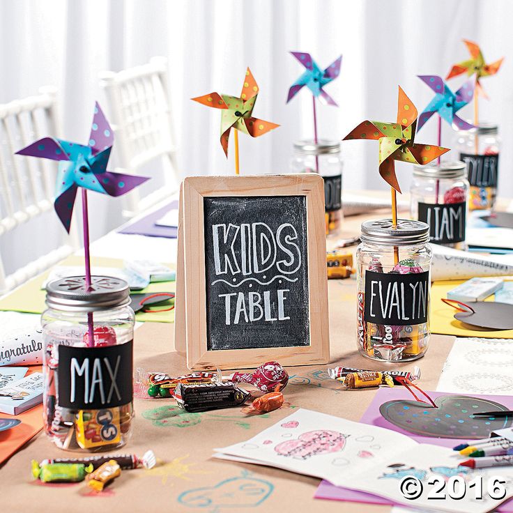 a table topped with lots of different types of crafting supplies and paper windmills