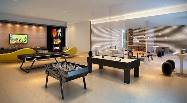 a living room filled with furniture and a pool table