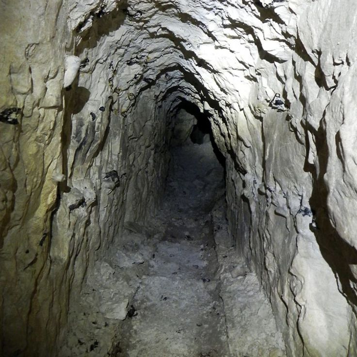 a narrow tunnel in the side of a mountain