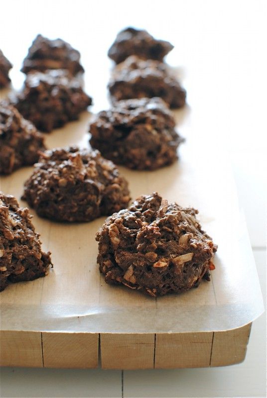 chocolate cookies are arranged on a cutting board and ready to be eaten by someone else