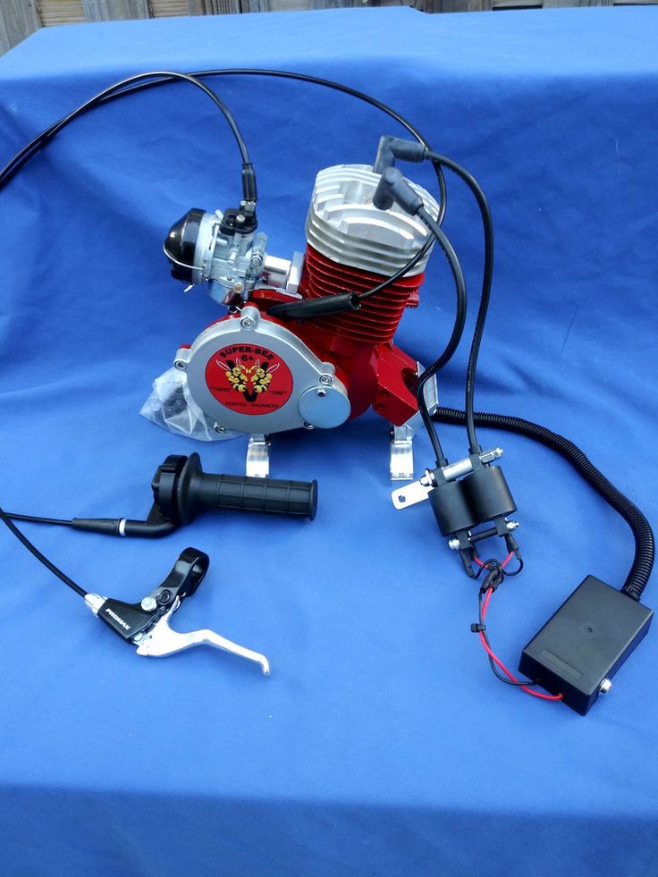 an image of a motorcycle engine on a blue tablecloth with wires and other accessories