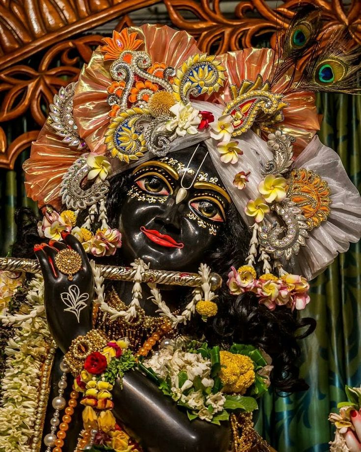 a statue of the hindu god srishri with flowers on it's head