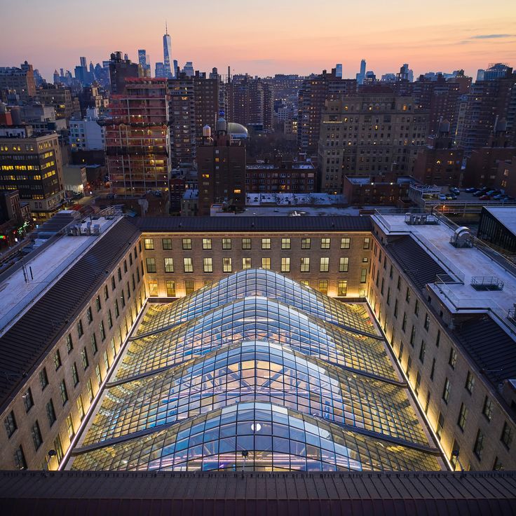 an aerial view of the roof of a building with many windows and lights at night