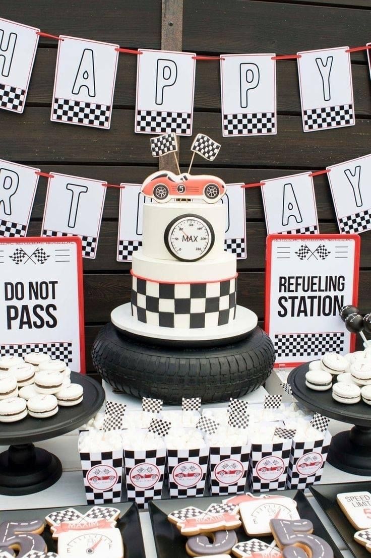 a birthday cake and dessert table at a race themed party