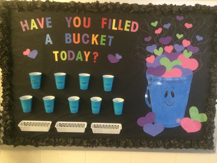 a bulletin board with cups and hearts on it that says have you filled a bucket today?