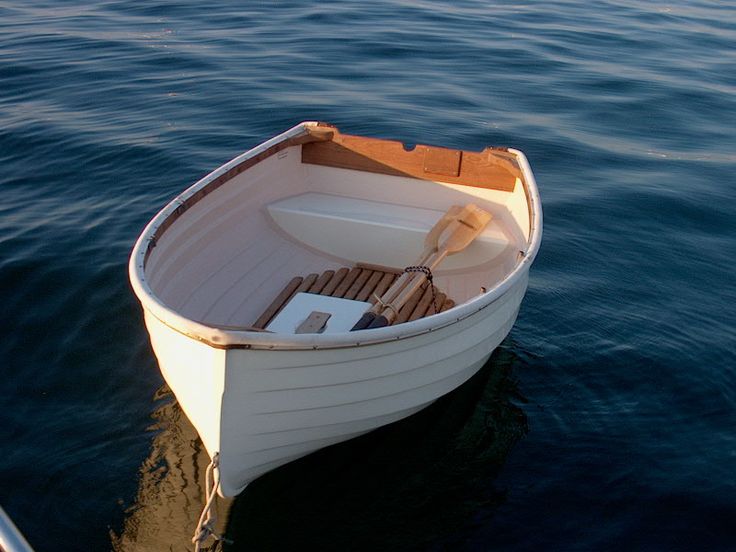 a small boat floating on top of a body of water