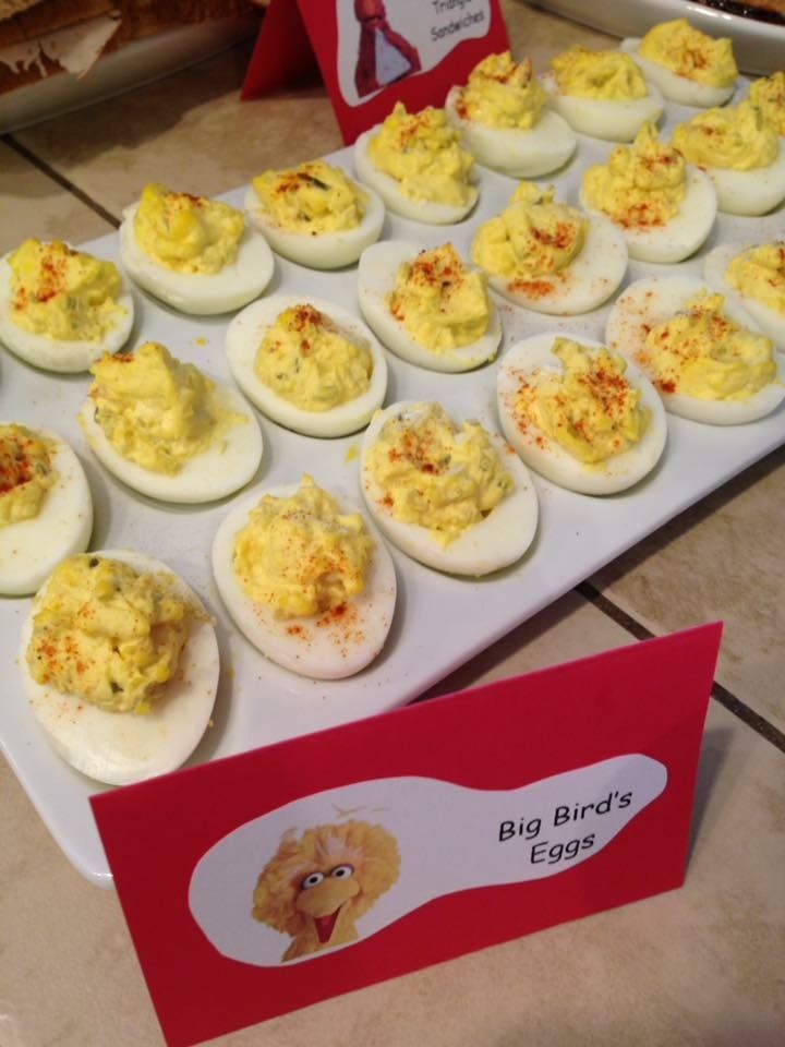 an assortment of deviled eggs on a tray with a sign for big bird's eggs