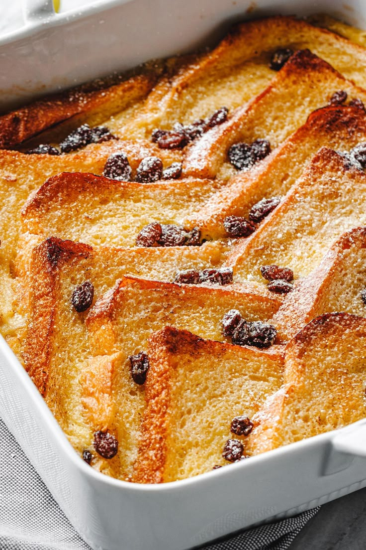 baked french toast with raisins in a white casserole dish