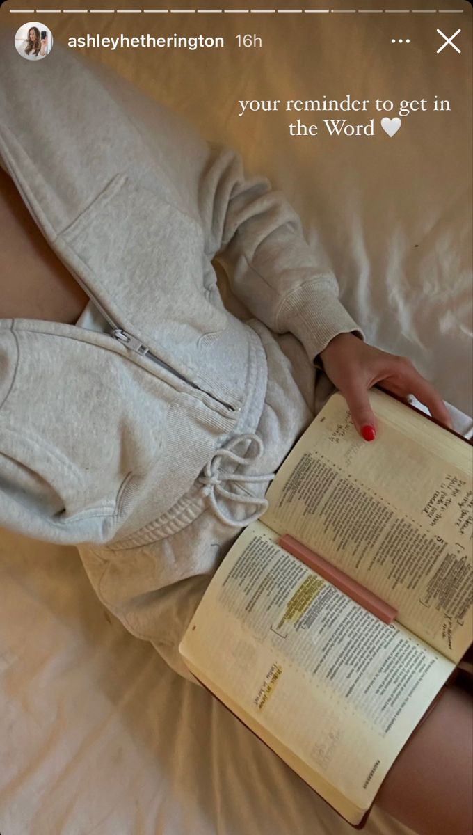 a person laying on a bed with an open book in their lap and the text above them reads, your reminder to get in the word