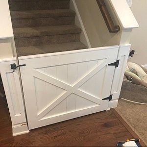 an open door is on the side of a stair case in a room with hardwood floors