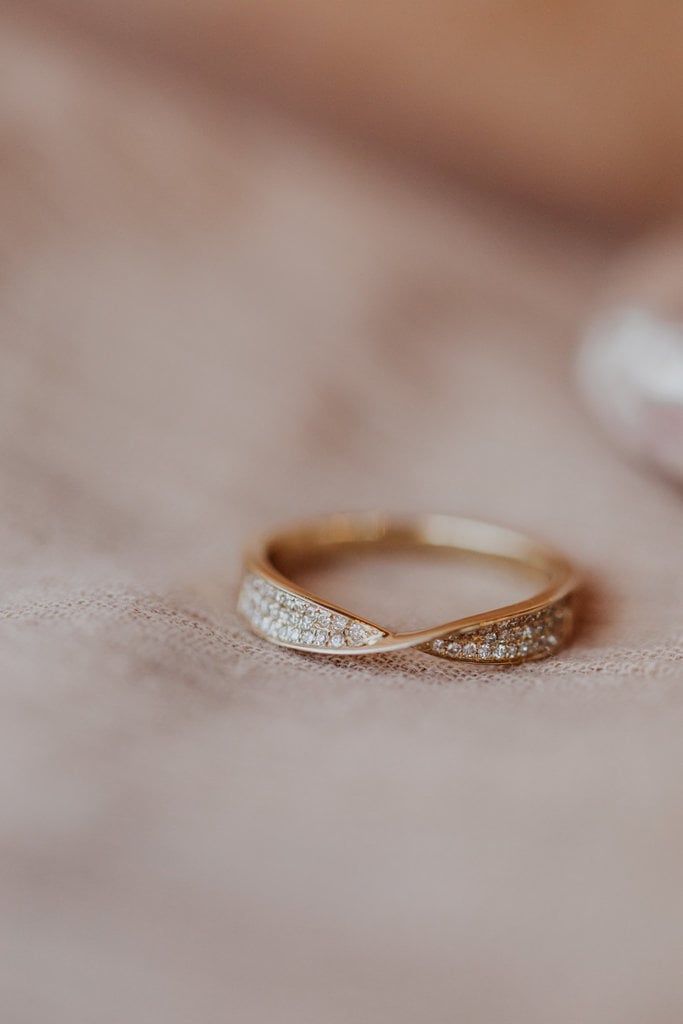 a close up of a wedding ring on a table