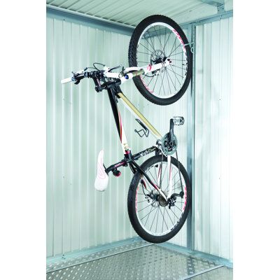 a bicycle is hanging upside down in a storage area