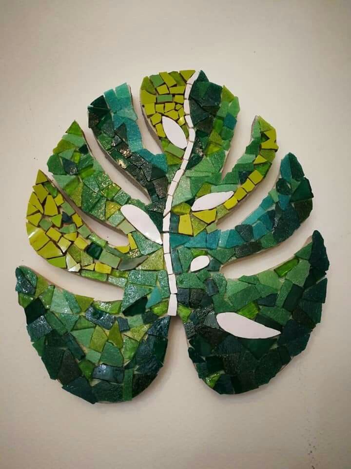 a green leaf made out of mosaic tiles