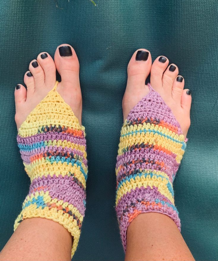 a woman's feet wearing colorful crochet socks