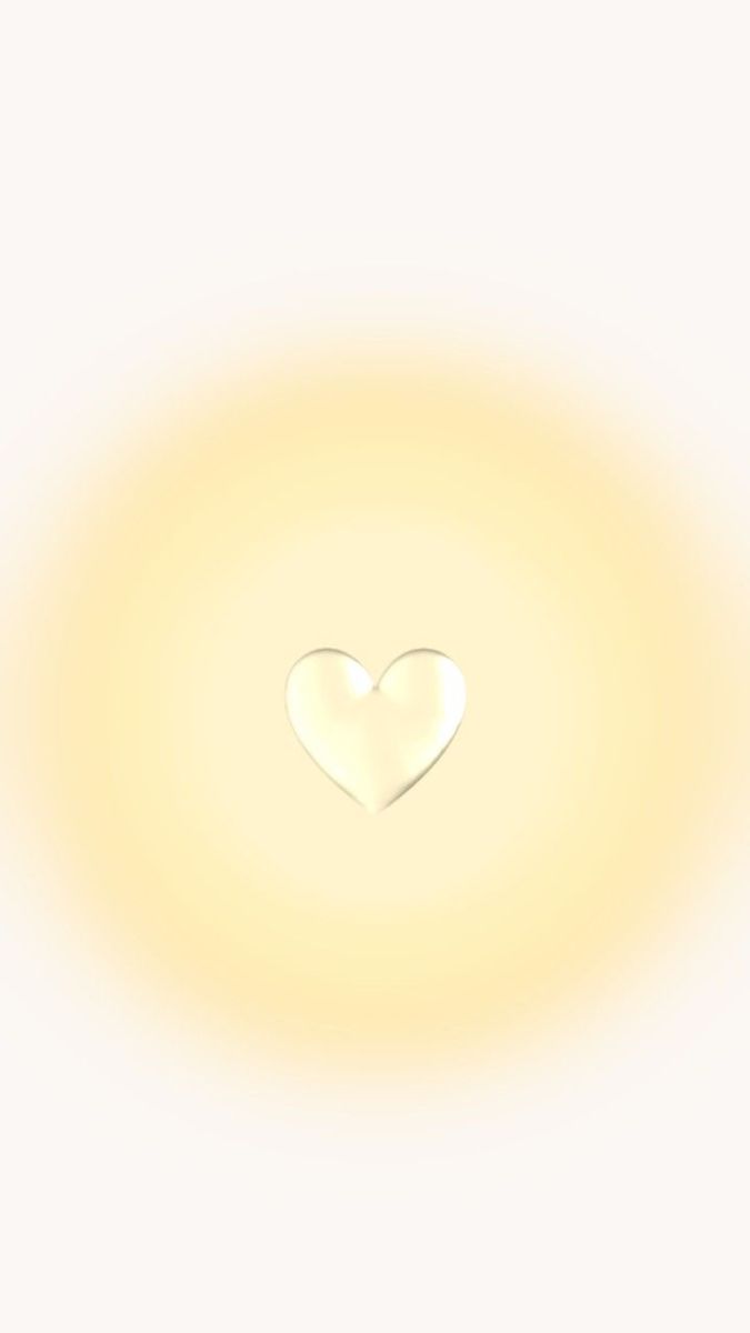 a white heart shaped object in the middle of a yellow circle with light shining through it