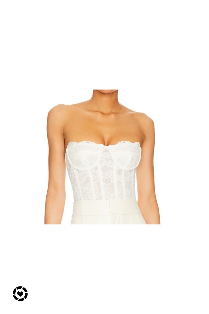 a woman wearing a white corset with lace on the bust and underwire