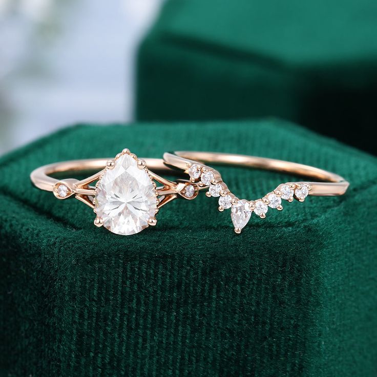 a close up of a ring on top of a green velvet cushion with diamonds in the middle