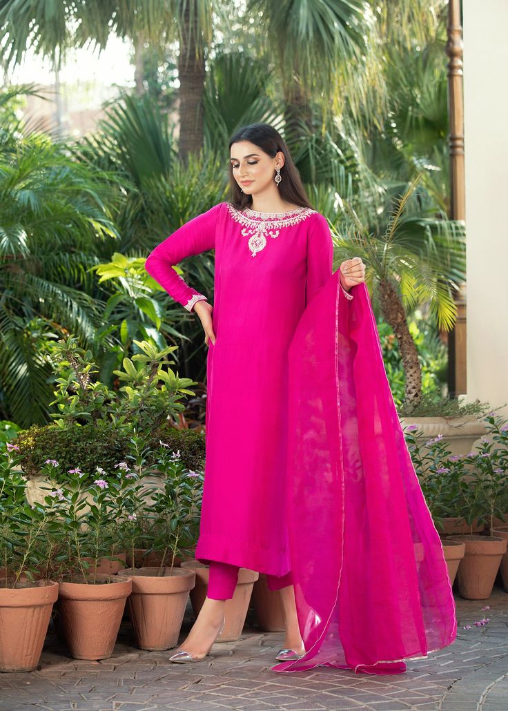 • Fuchsia pink rawsilk handworked shirt with work on neckline (front and back) and sleeves with zardozi and dabka • Paired with matching rawsilk cigarette pants • Add on a matching pure katan organza dupatta with gota on four sides (Includes Shirt and pants) Pink Cotton Silk Lawn Suit With Traditional Drape, Pink Cotton Silk Lawn Suit With Dabka Work, Pink Silk Salwar Kameez With Dabka Work, Pink Unstitched Raw Silk Suit, Pink Raw Silk Unstitched Suit, Pink Chanderi Lawn Suit With Dabka, Designer Pink Silk Lawn Suit, Pink Raw Silk Unstitched Suit With Resham Embroidery, Pink Silk Lawn Suit Designer Wear