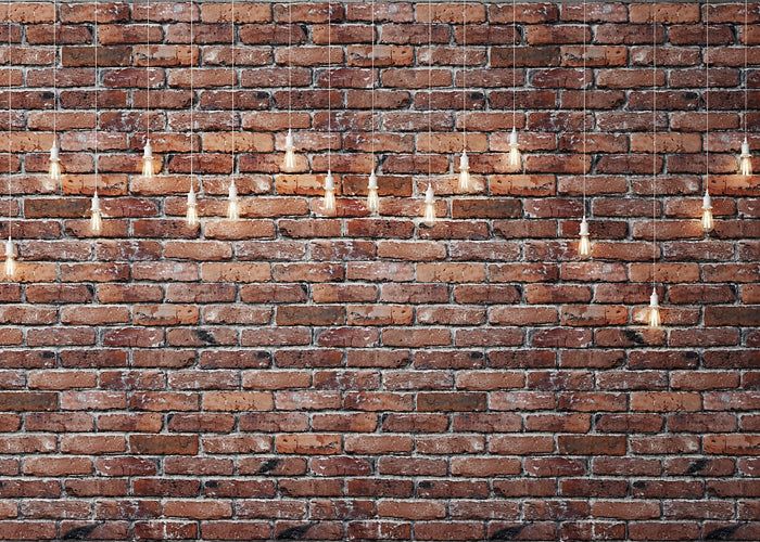 a brick wall with many lit candles on it