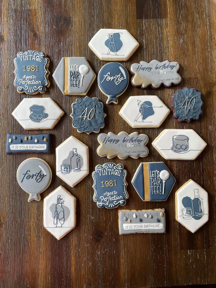 decorated cookies are arranged on a wooden table