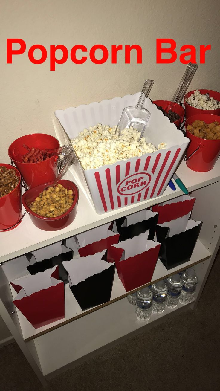 popcorn bar with red buckets full of popcorn