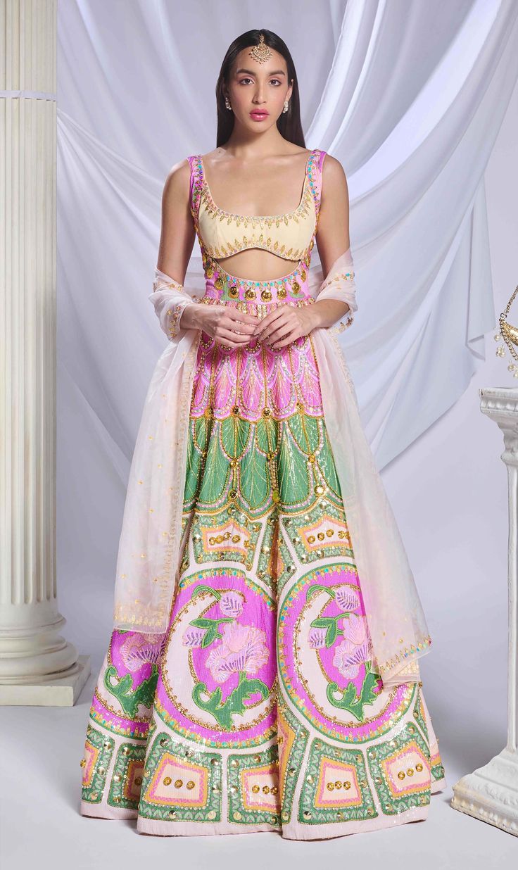 Shine in our multicolored sequins-printed anarkali, featuring a yoke cut and richly embroidered with metal chains, crystals, glass cut beads, and metal accents. Paired with a delicate baby pink tulle dupatta, this ensemble combines vibrant sparkle with soft, feminine elegance. Pink Silk Set With Sequins, Pink Sequined Silk Set, Pink Silk Sequined Set, Pink Chandbali Choli For Eid, Pink Silk Sets With Mirror Work, Embellished Anarkali Set For Festivals, Festival Embellished Anarkali Set, Festive Embellished Anarkali Set, Floor-length Multicolor Embellished Sharara