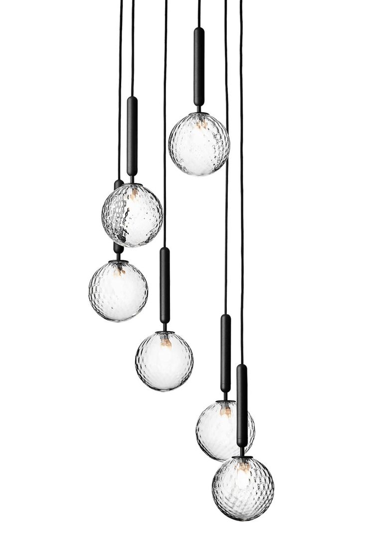 five clear glass globes hanging from a black metal rod and one light bulb is turned on