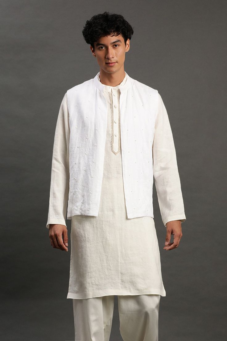 Off-white linen bundi with pearl embroidery. Comes with white pyjama and a kurta with embroidered placket.
Components: 3
Pattern: Embroidered
Type Of Work: Pearl
Neckline: Band collar
Sleeve Type: Full
Fabric: Linen
Color: White
Other Details: 
Closure : Front buttons
Occasion: Mehendi and Puja,Sangeet - Aza Fashions Kurta Set For Men, Pearl Embroidery, White Pajamas, Linen Color, Fashion App, Band Collar, Kurta Set, Aza Fashion, White Linen