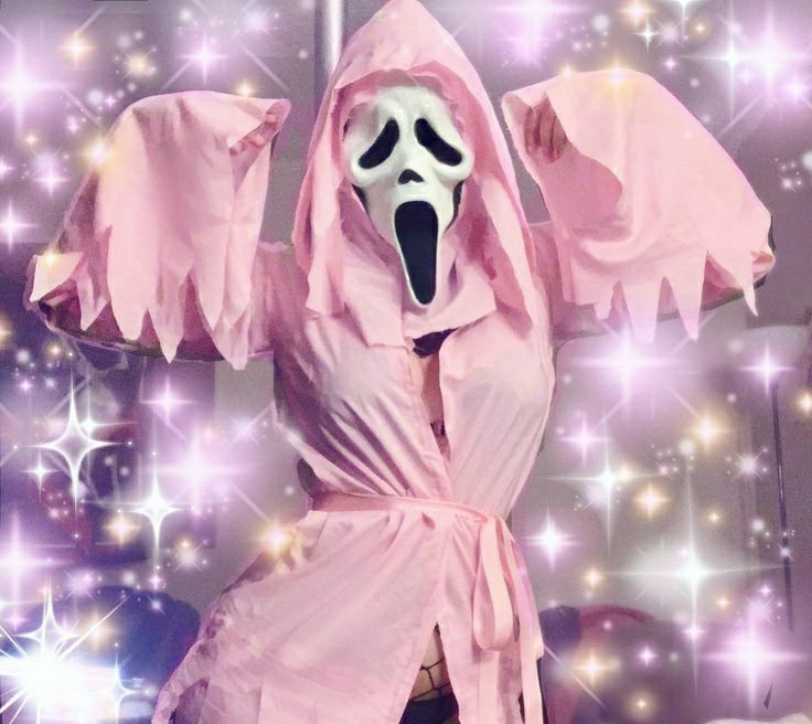 a person in a pink robe and mask